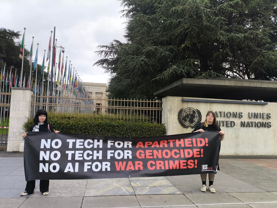 Activists Freya and maia arson crimew holding a banner saying "No Tech for Apartheid, No Tech for Genocide, No AI for War Crimes"
